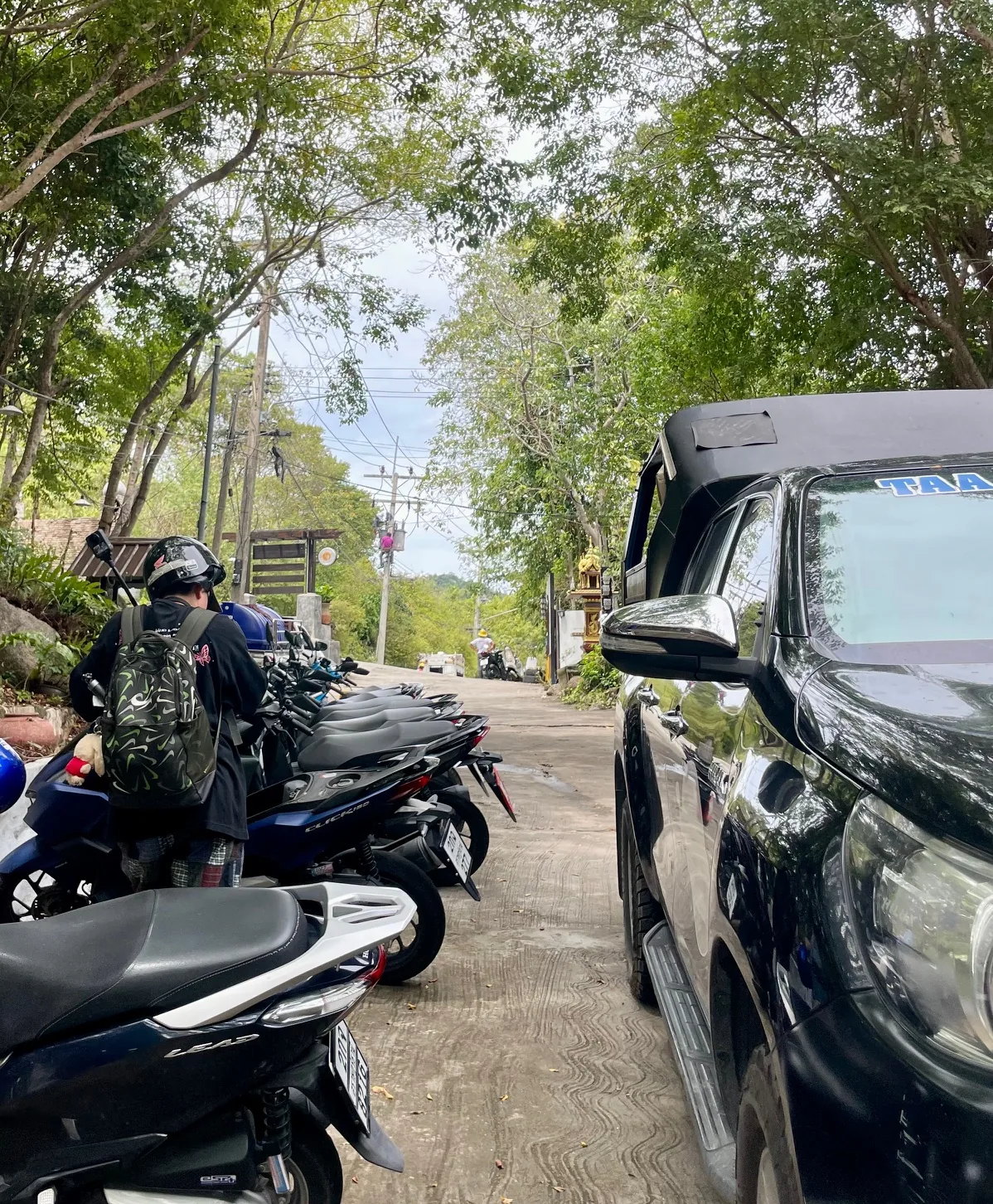 Motorbikes parked on a steep hill in Koh Tao, Thailand, roads can be challenging for new riders.