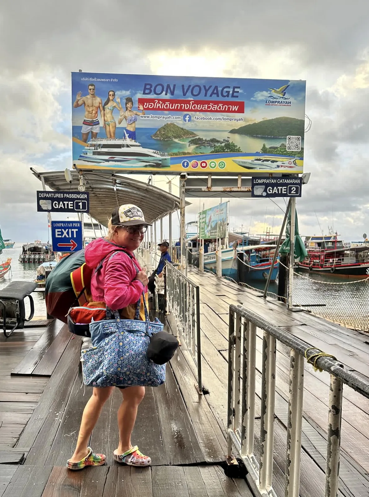 A woman traveler waiting for a ferry boat on a dock