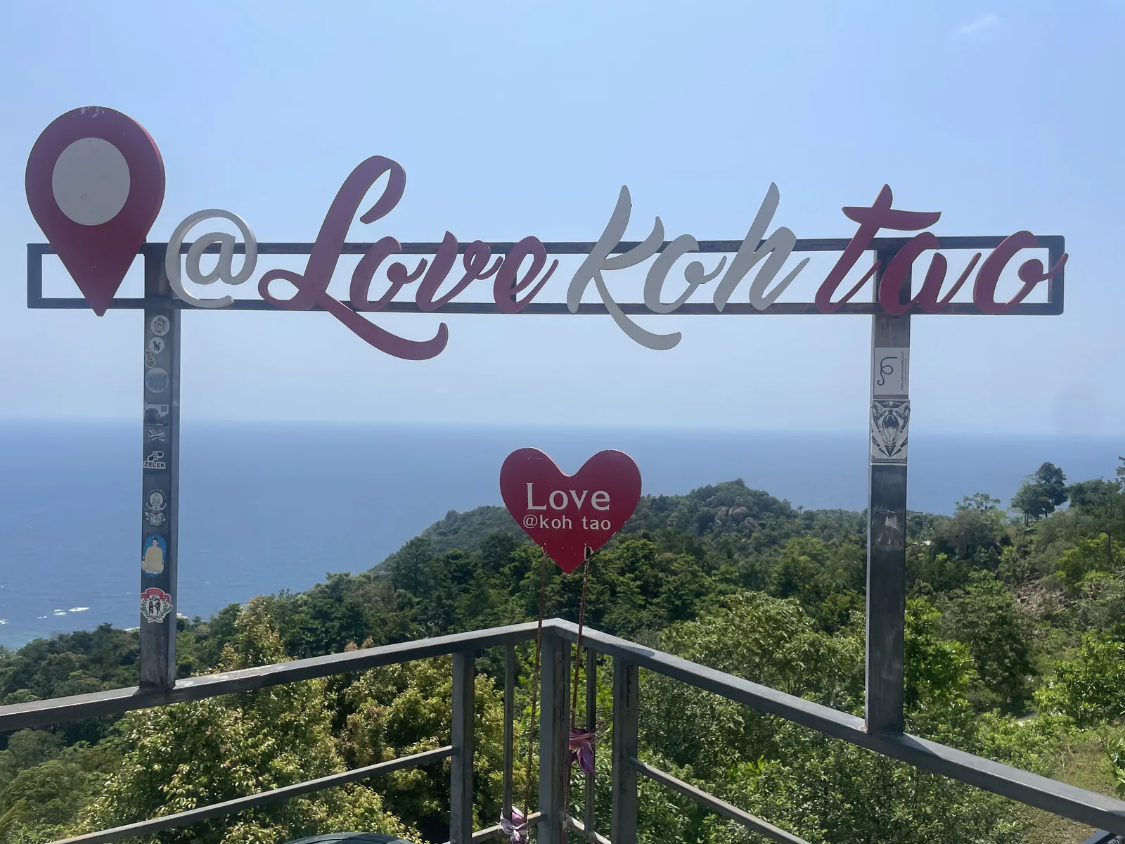A sign over the ocean at a look out love Koh tao