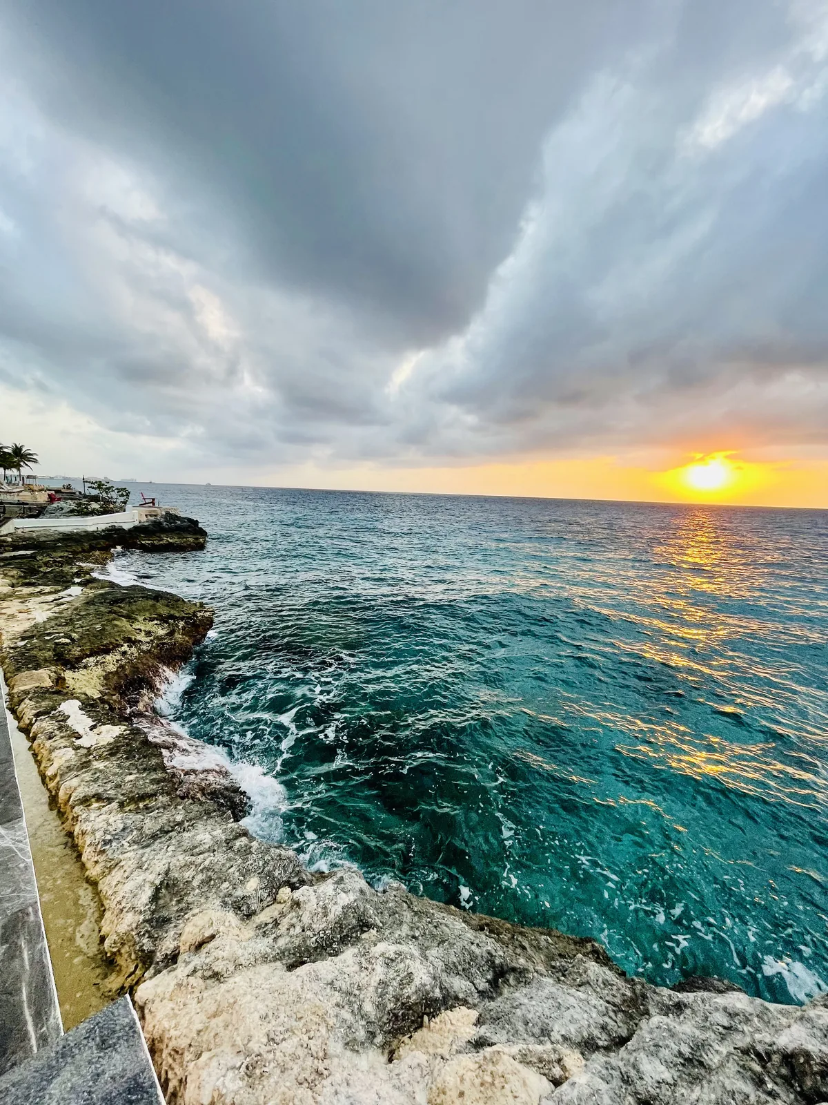 Sunset on a rugged coastline with blue water
