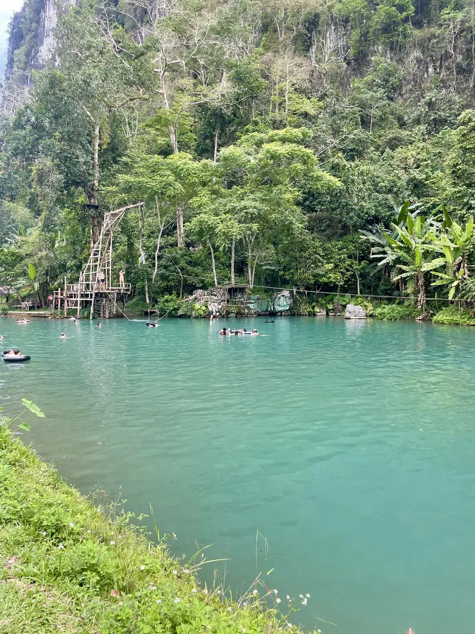 Turquoise water and a wooden jumping platform at one of Vang Vieng's Blue Lagoons