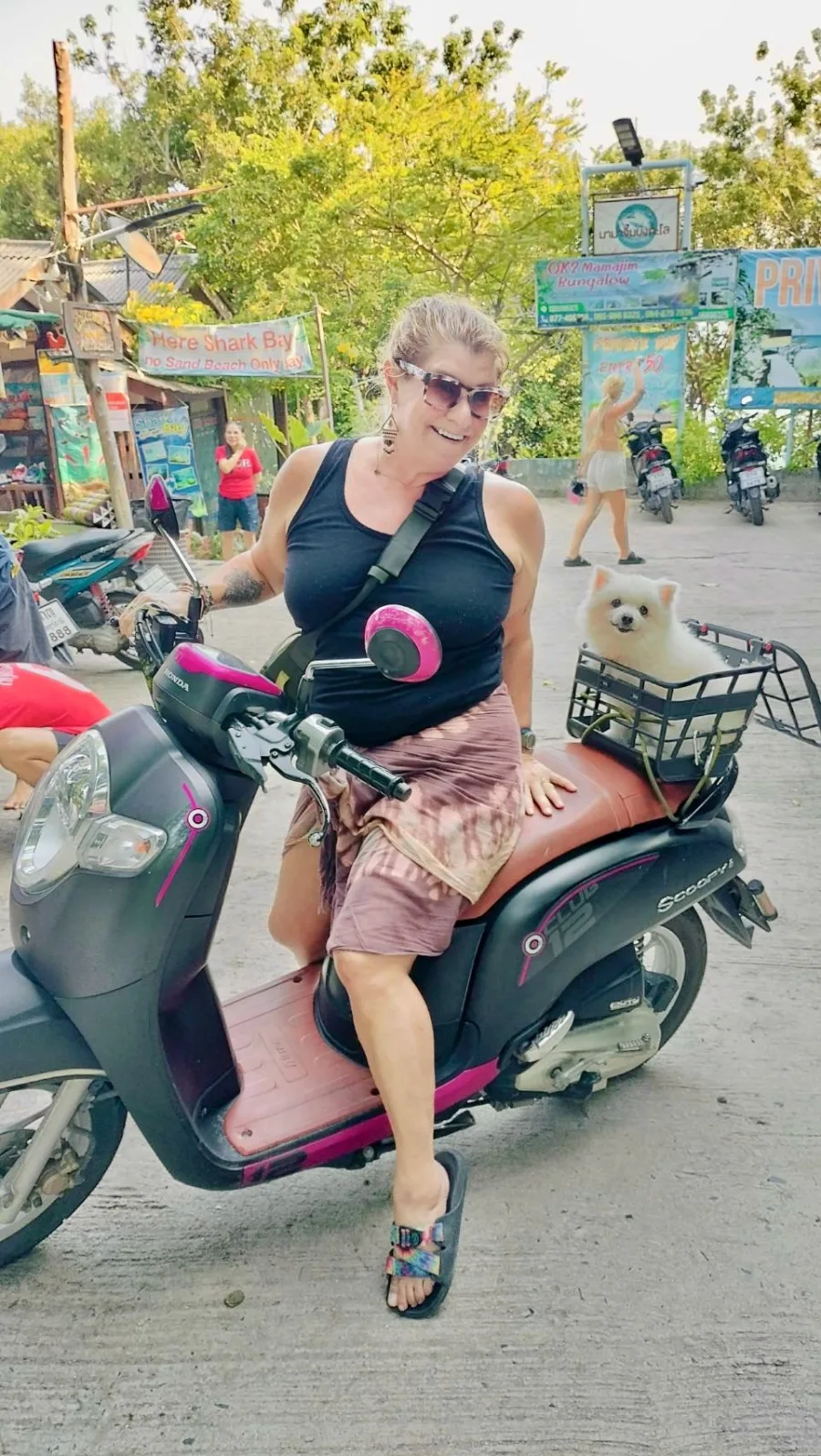 Jennifer Varner, Gal Goes Solo founder, on her scooter with her dog in Koh Tao, Thailand
