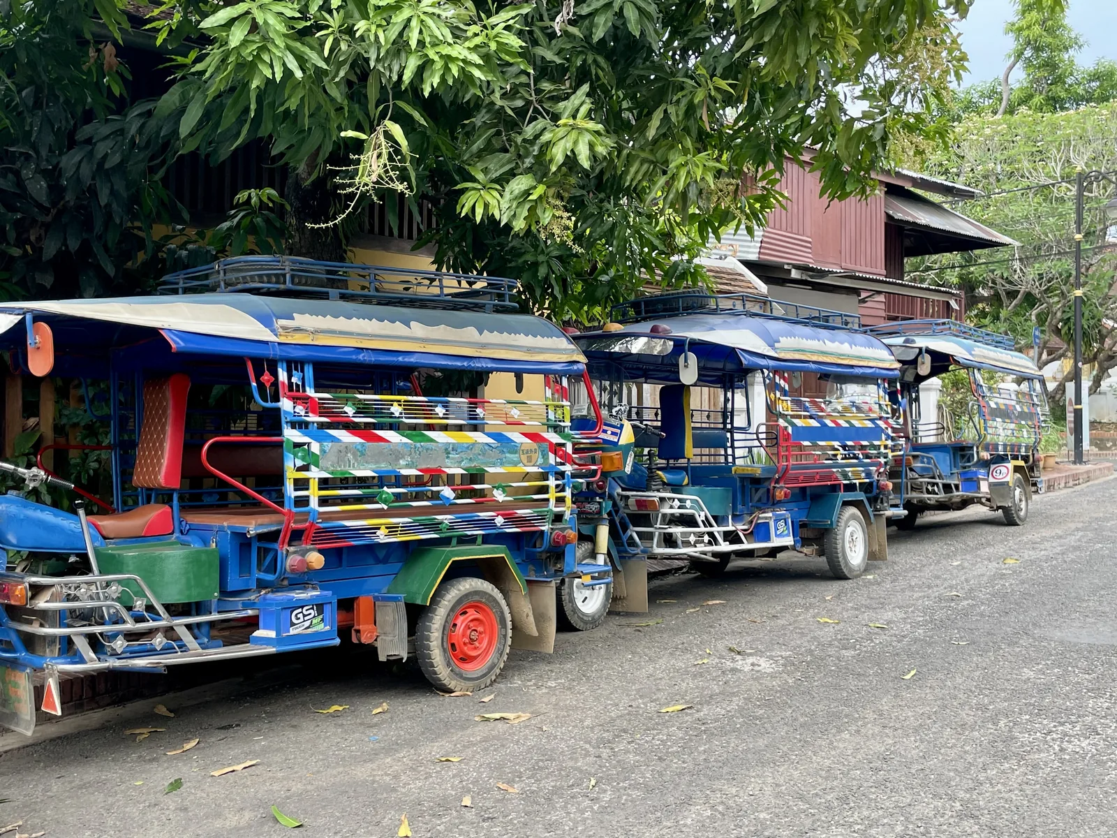 Blue tuk-tuks on a street in Laos