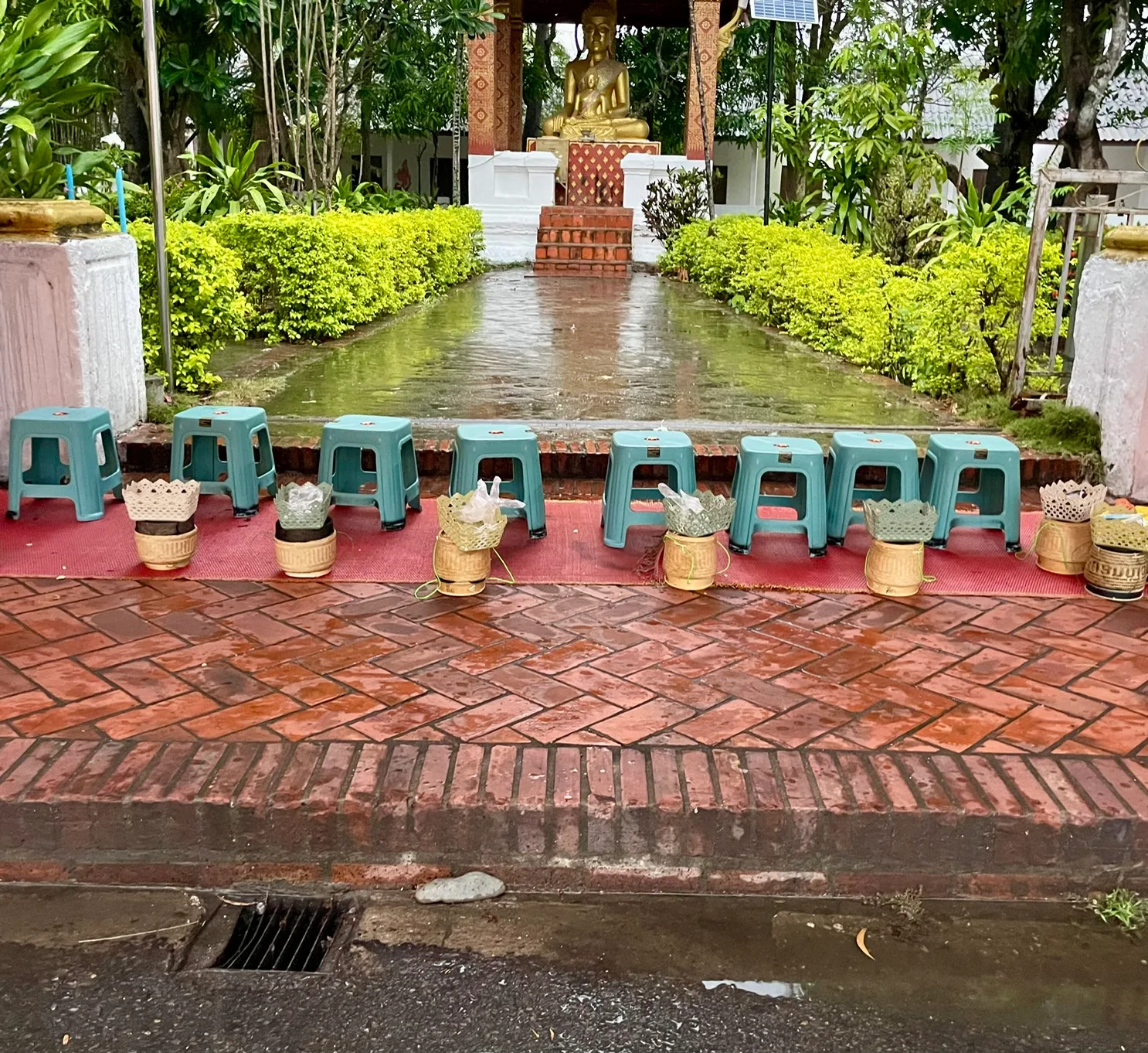 Low stools in front of a Buddha statue in Luang Prabang Laos